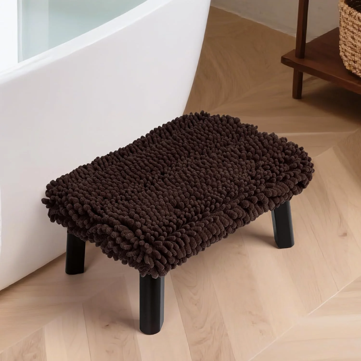 The Sunlit one-step stool with a chenille top beside a bathtub