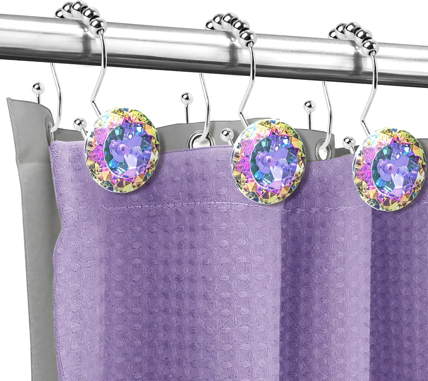 Sunlit crystal shower curtain hooks holding a purple curtain