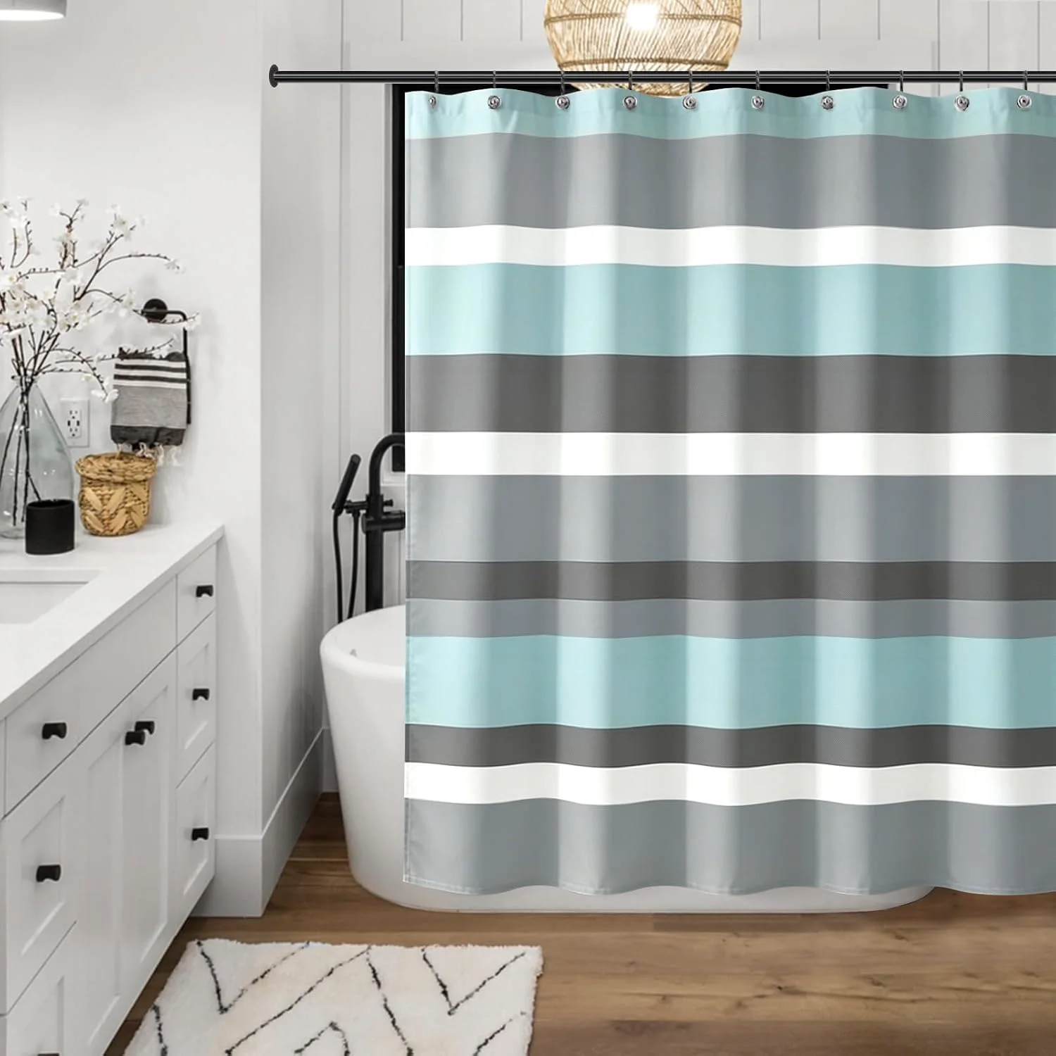 A Sunlit aqua and grey striped fabric shower curtain hanging in a bathroom